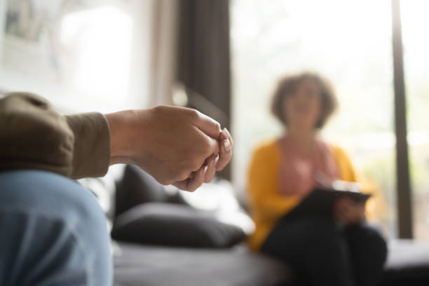 Close-up photo of a teenage girl in a therapy session with her psychologist.